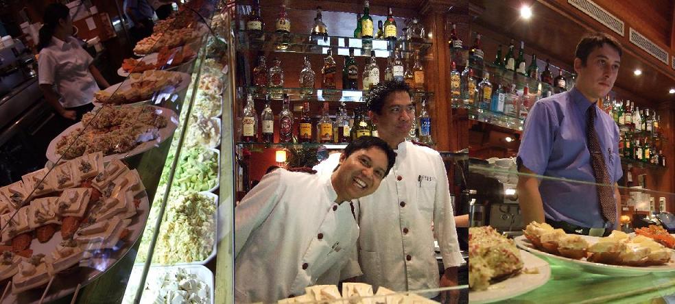 A long bar of finger food, our happy waiters, suave captain of the bar…